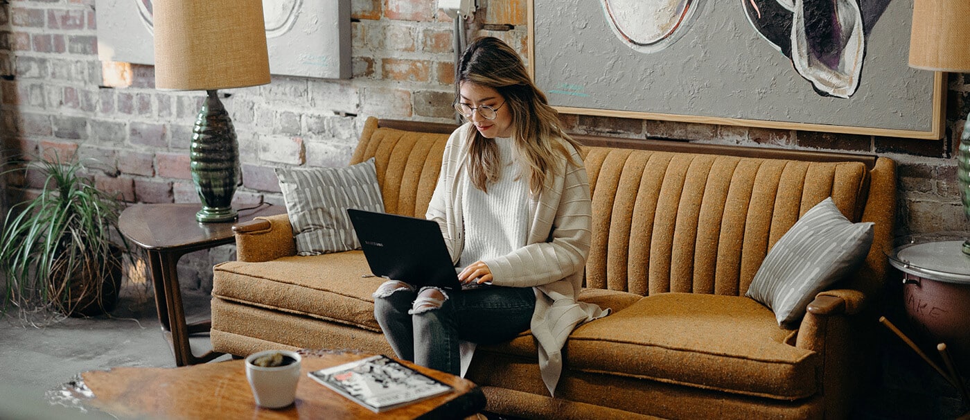 Woman working on laptop in a cafe