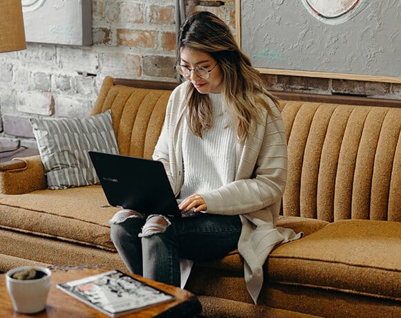 Woman working on laptop in a cafe