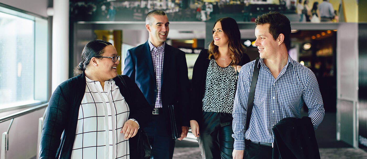 Group of professionally dressed workers walking