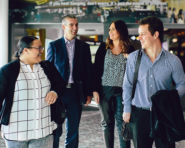 Group of professionally dressed workers walking